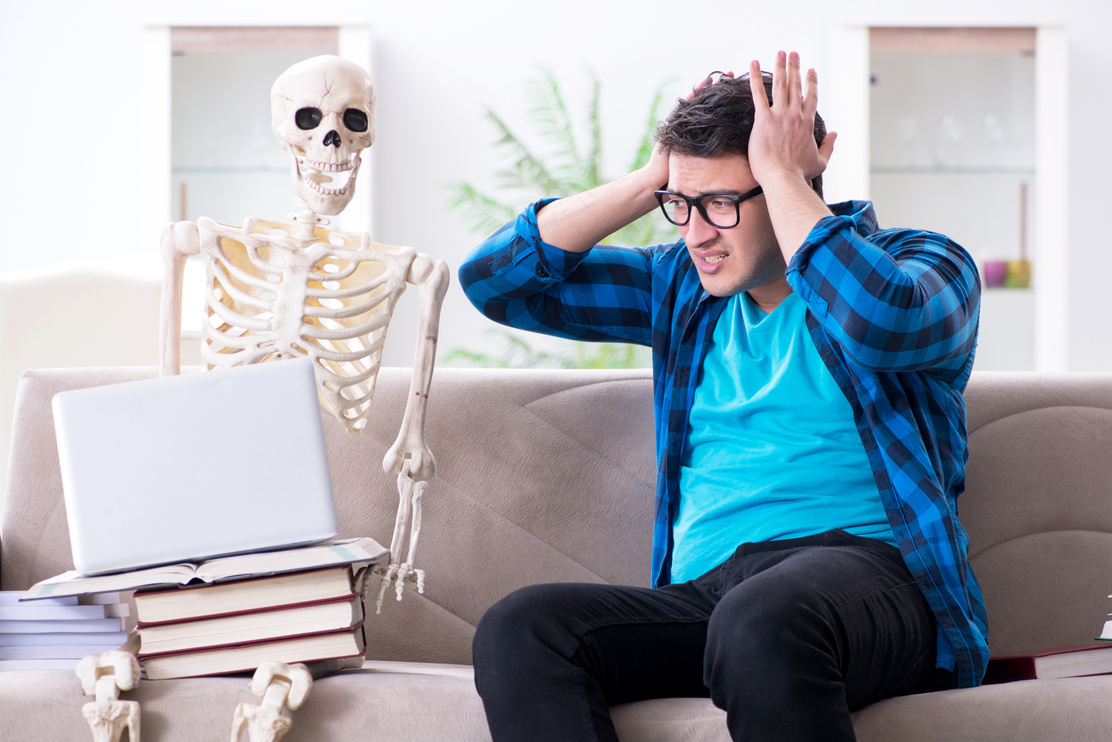Student Studying with Skeleton Preparing for Exams